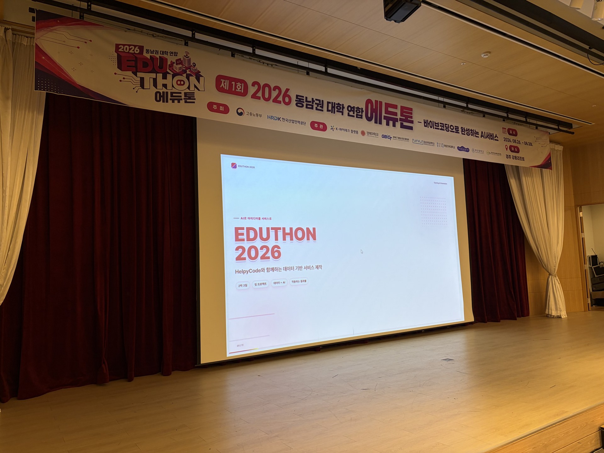 행사 배너와 개회 슬라이드. 제1회 2026 동남권 대학 연합 에듀톤 — 바이브코딩으로 완성하는 AI서비스.